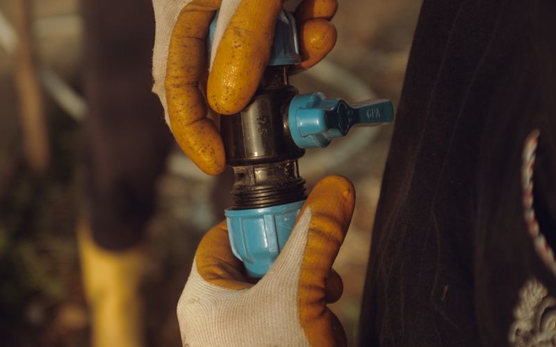Plumber connecting an outdoor water line fitting